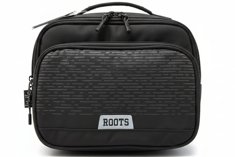 Black bag with 'ROOTS' logo on a gray textured surface