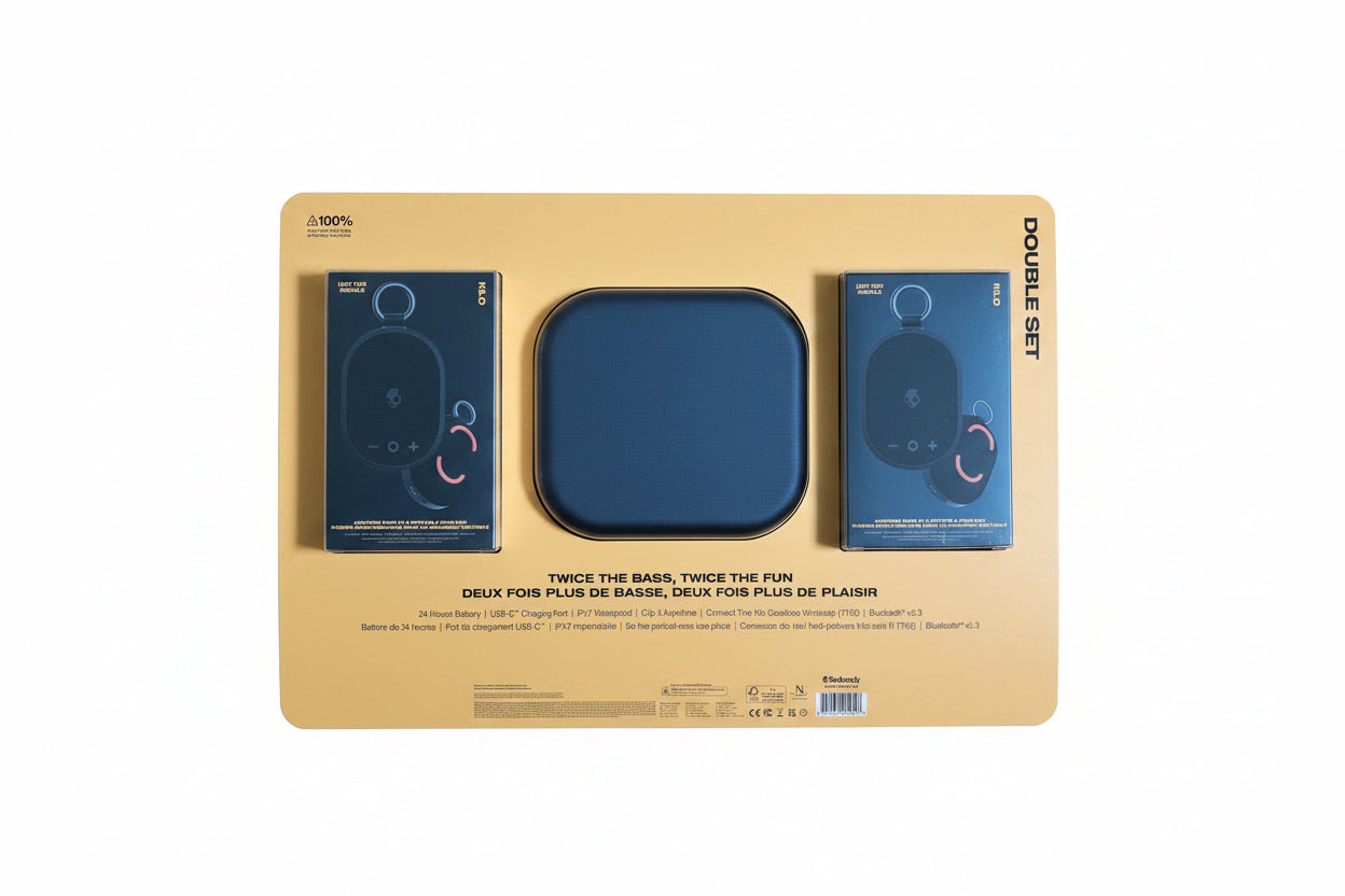 Packaging for a set of speakers with blue speakers and beige base on a dark background