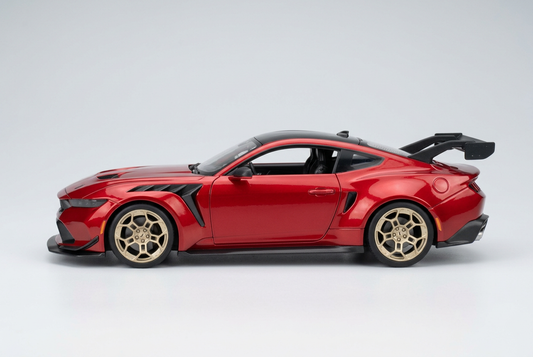 Side profile of the red Maisto 2025 Ford Mustang GTD 1:18 die-cast model car with gold wheels
