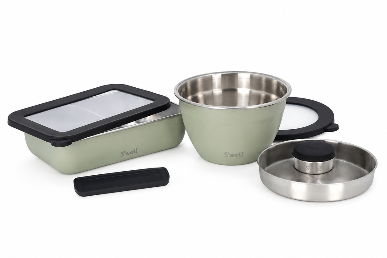 Set of stainless steel containers with lids on a white background