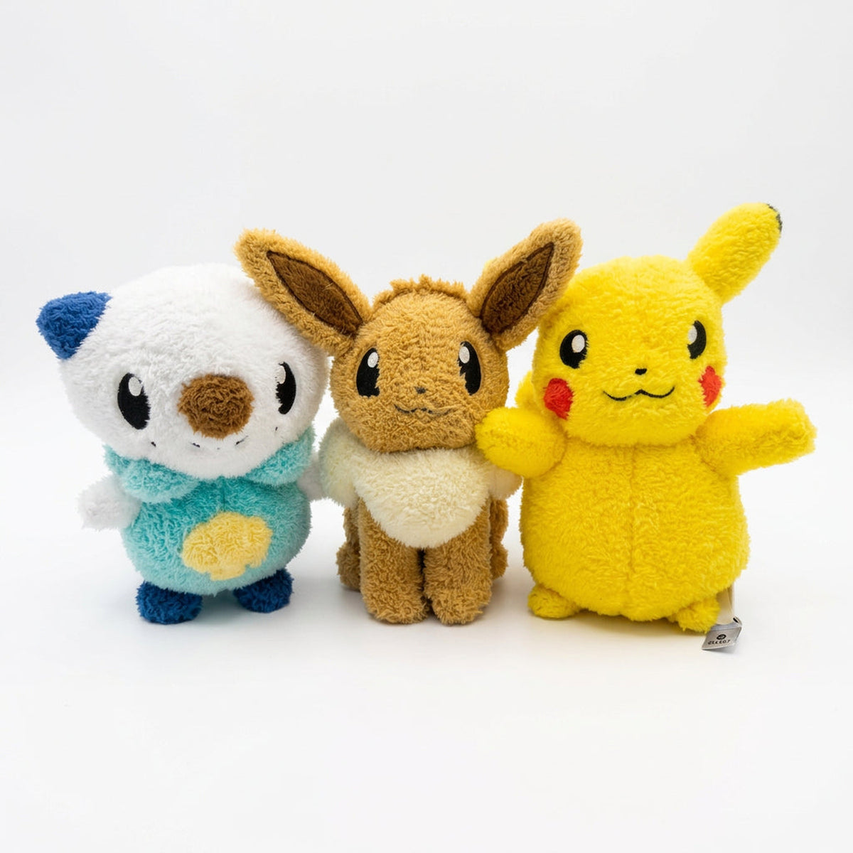 Oshawott, Eevee and Pikachu cuddly plush toys side by side out of the box