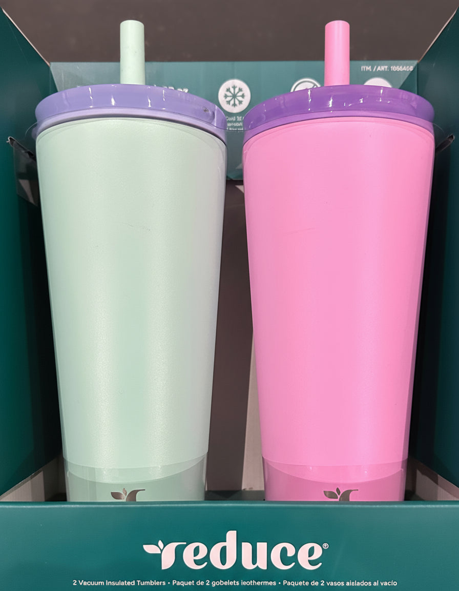 Two tumblers, one white and one pink, with purple lids and straws, in a box with 'reduce' branding.