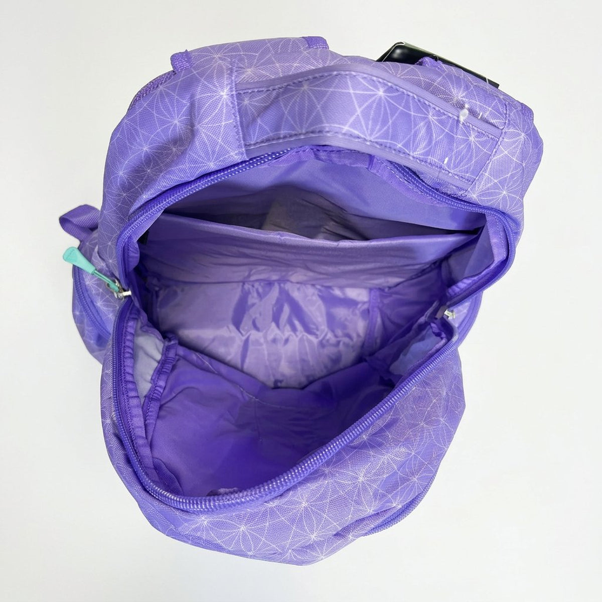 Lilac Roots backpack opened from above showing the lined main compartment and laptop sleeve