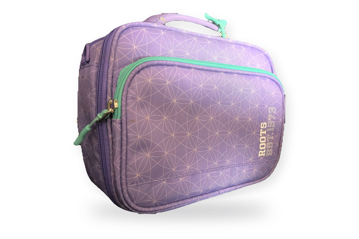 Roots insulated lunch bag in lilac with a white geometric print and teal zippers, angled view