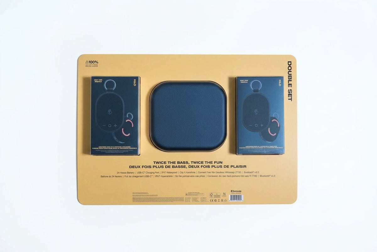 Packaging for a set of speakers with blue speakers and beige base on a dark background