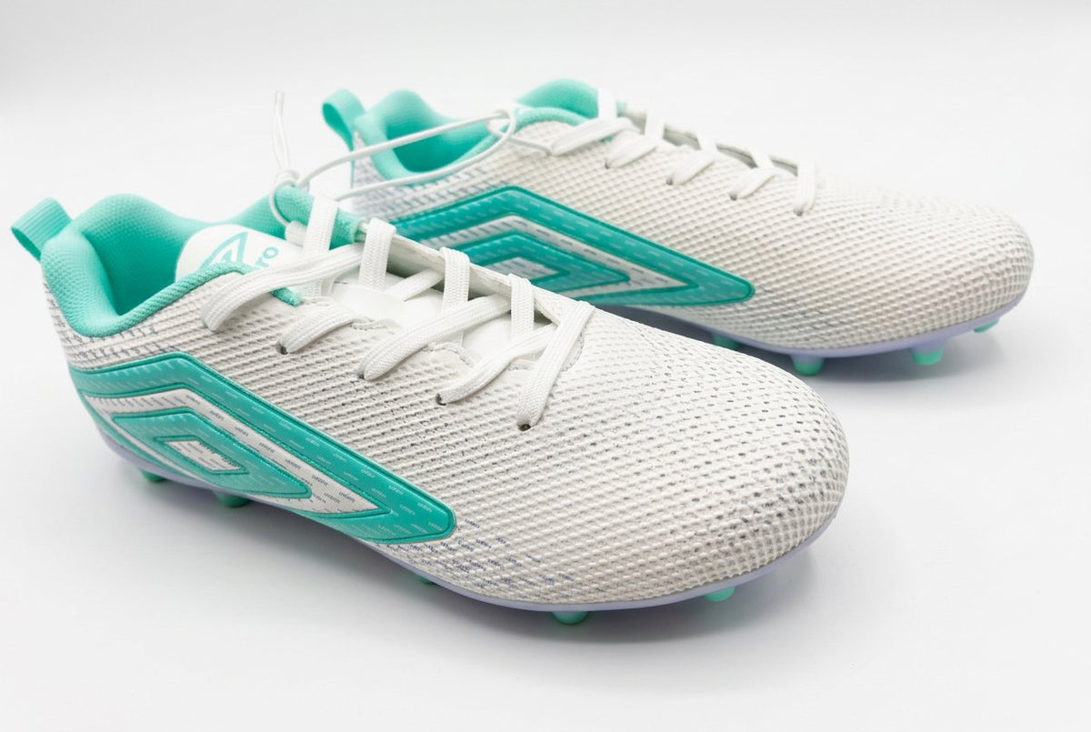 White and turquoise running shoes on a black surface