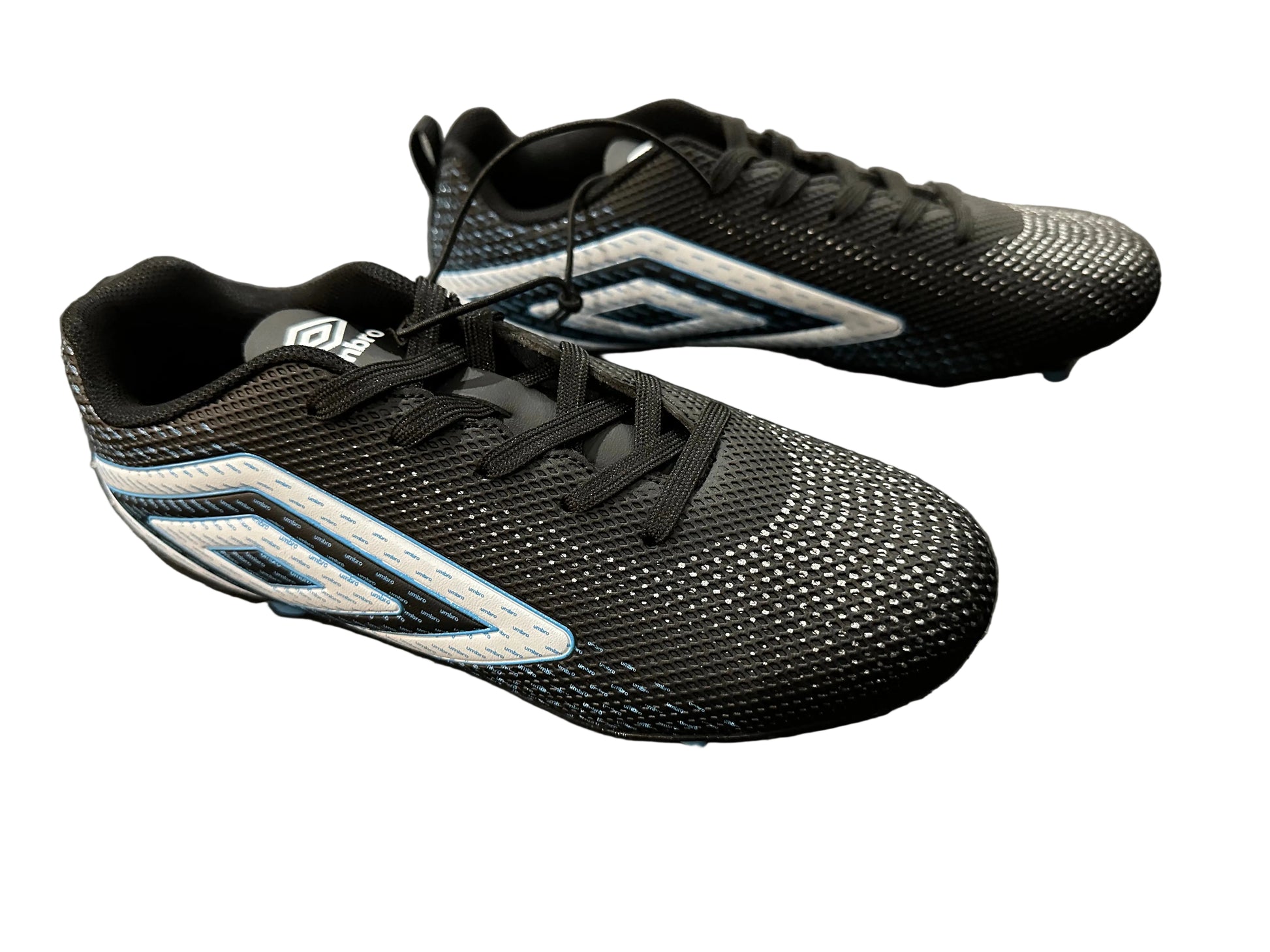 Black sports shoes with blue accents on a dark textured surface