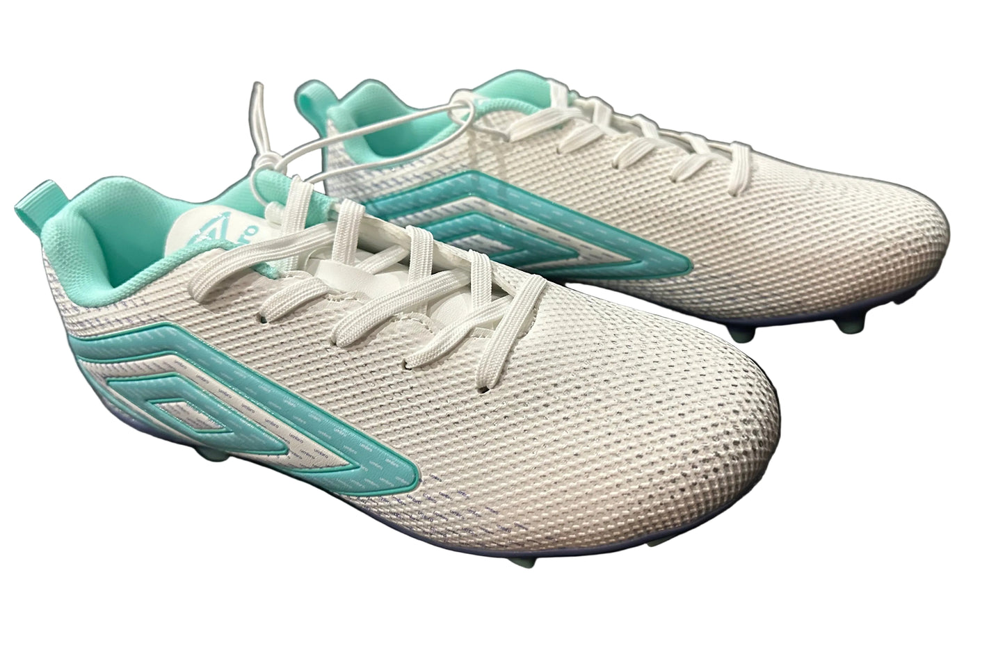 White and turquoise running shoes on a black surface